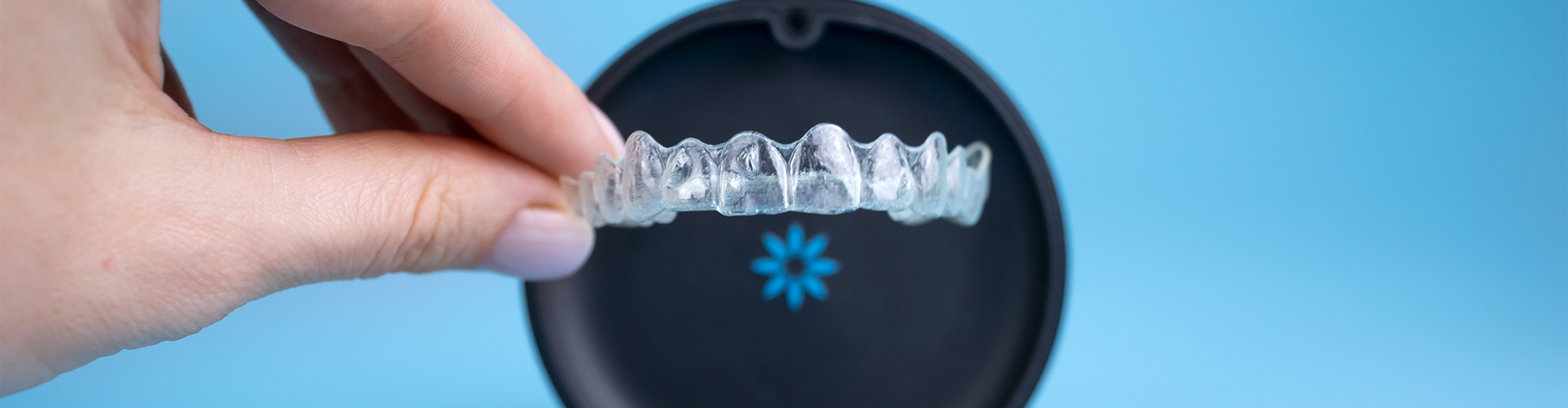 Hand placing clear in holder.